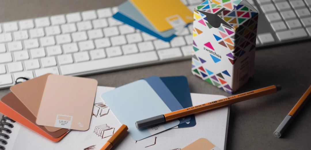 Desk with color samples, pencils and brand design work