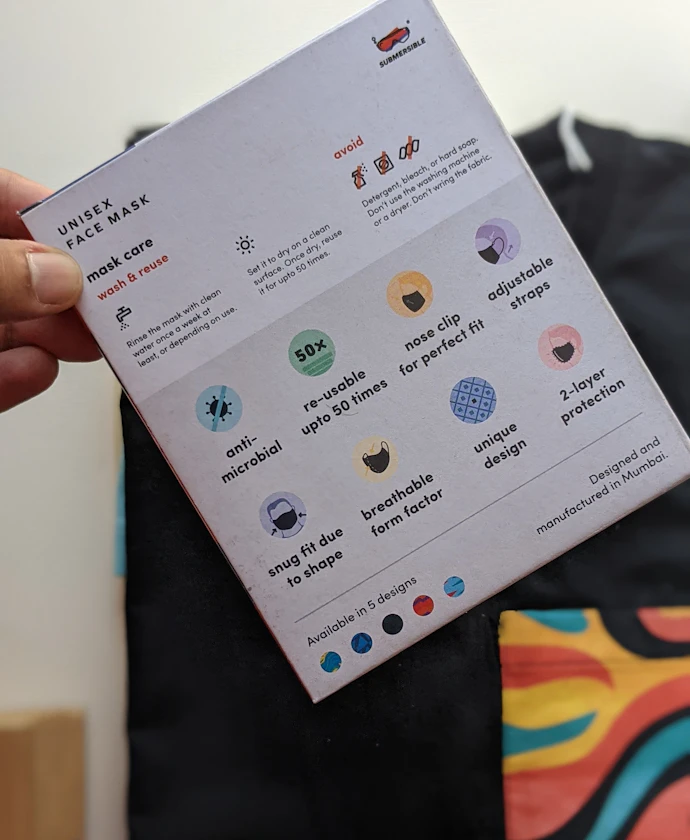 Hand holding a printed card showing a brand's icon set and color palette