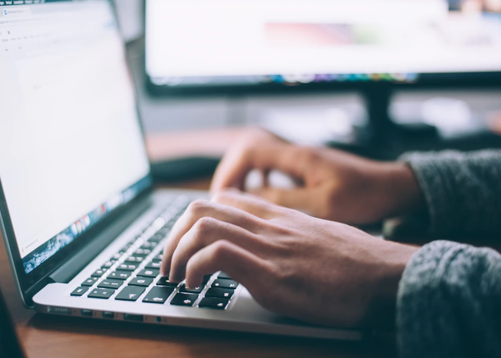 Copywriter typing on a laptop