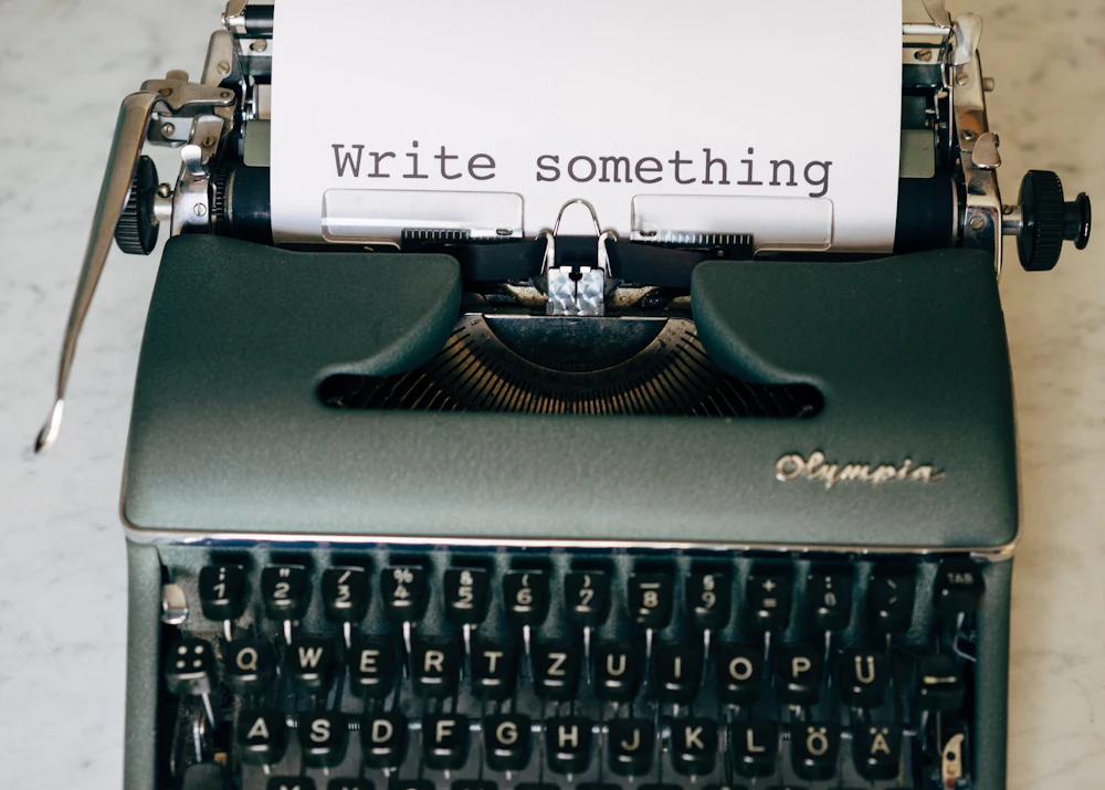 Typewriter with a sheet of paper reading Write something