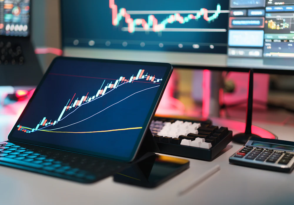 Tablet showing a financial chart on a desk