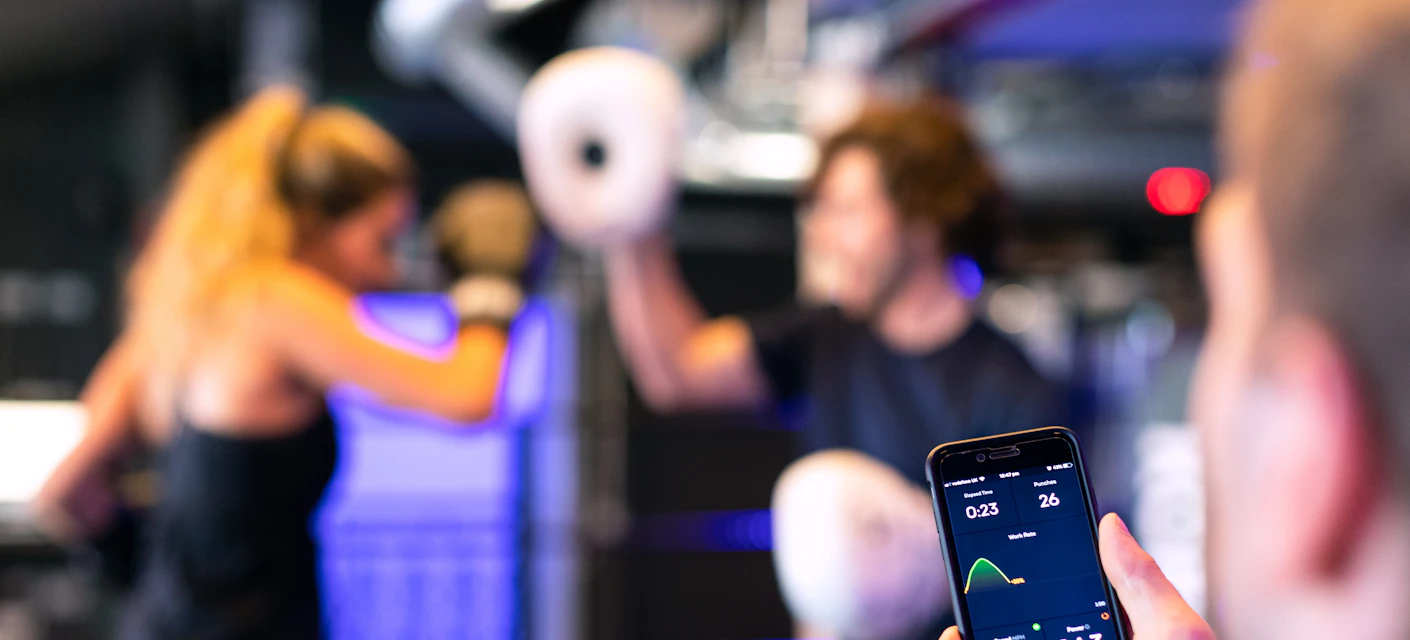 Fitness tracking app on a smartphone in a gym