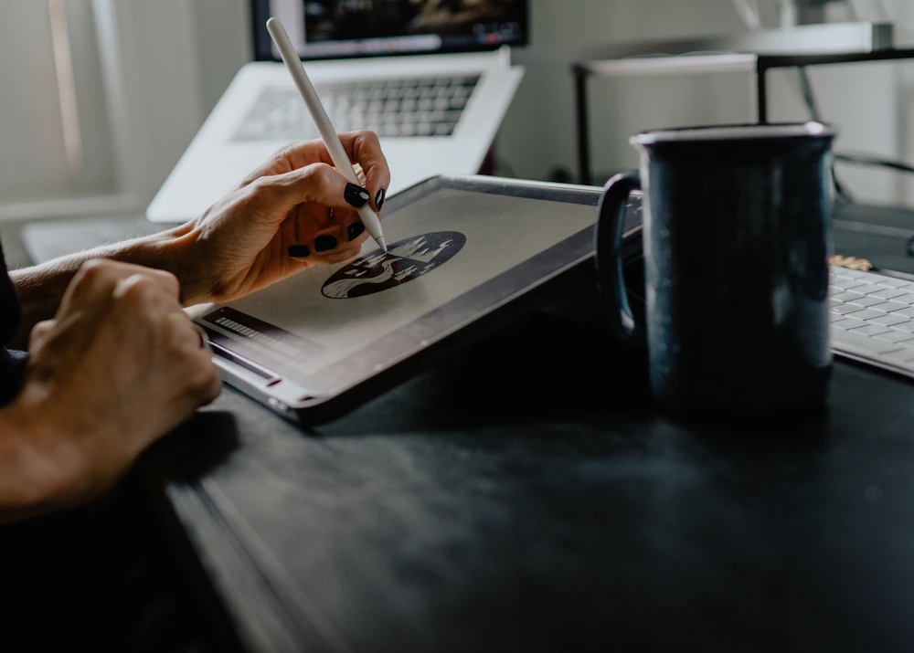 Designer drawing an illustration on a tablet with a stylus