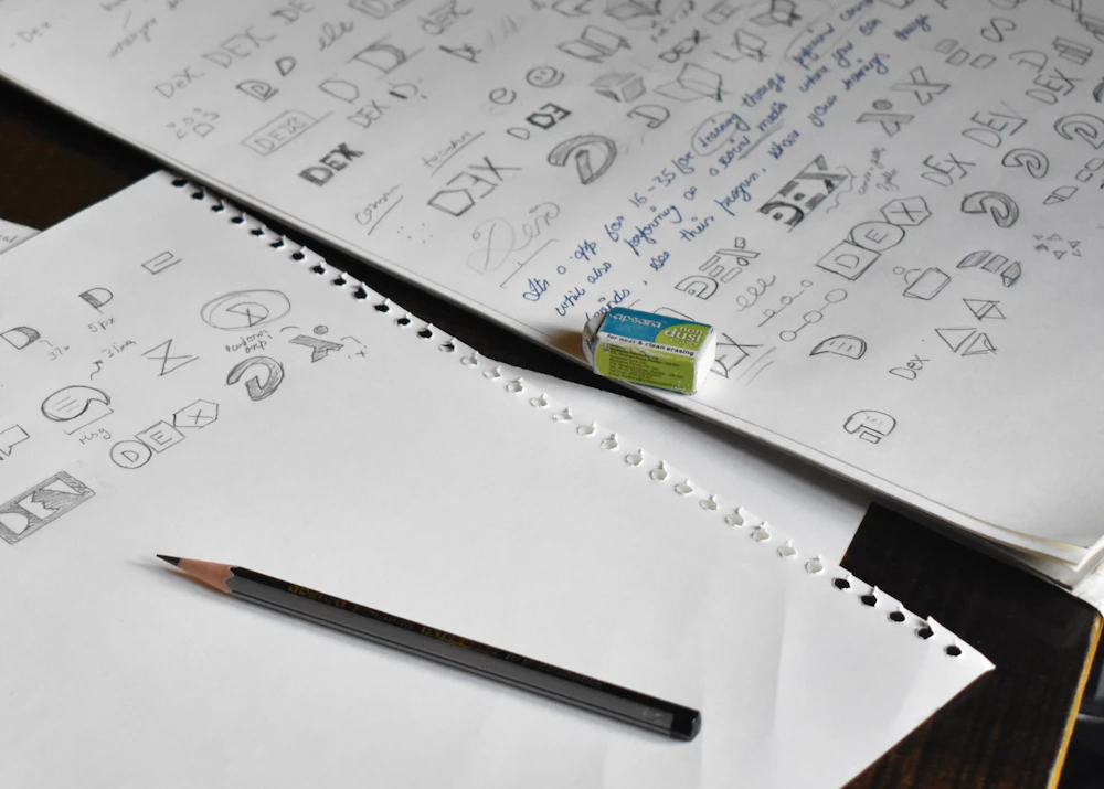 Logo design sketches on paper with a pencil