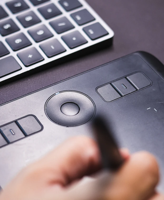 Designer drawing with a pen on a graphics tablet