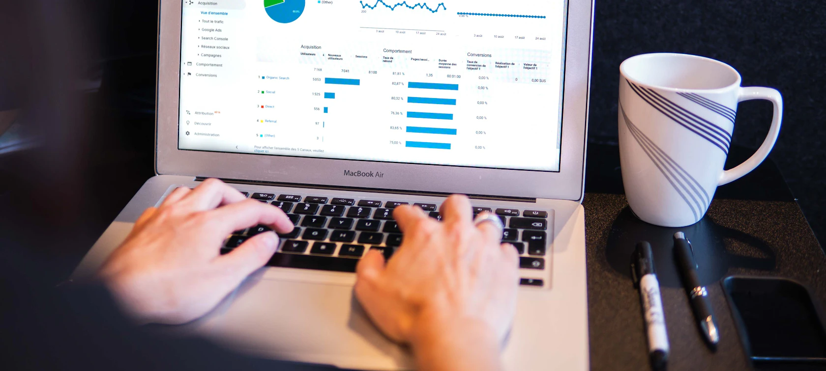 SEO specialist reviewing website analytics dashboards on a laptop