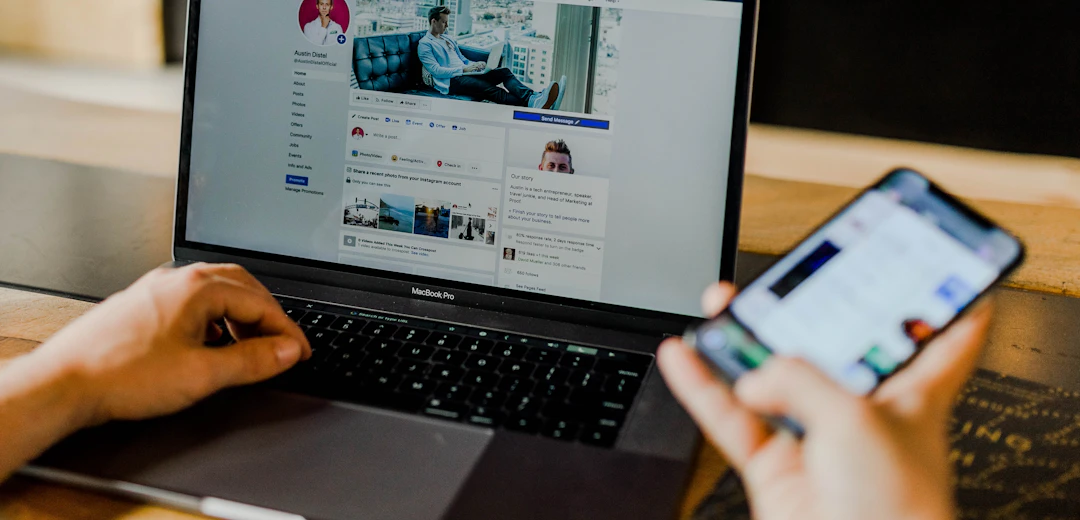 Person using a laptop and smartphone for social media