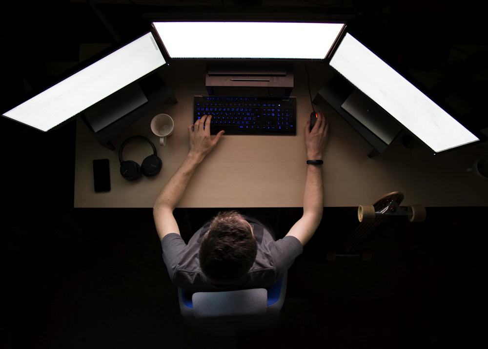 Software engineer working at a multi-monitor workstation