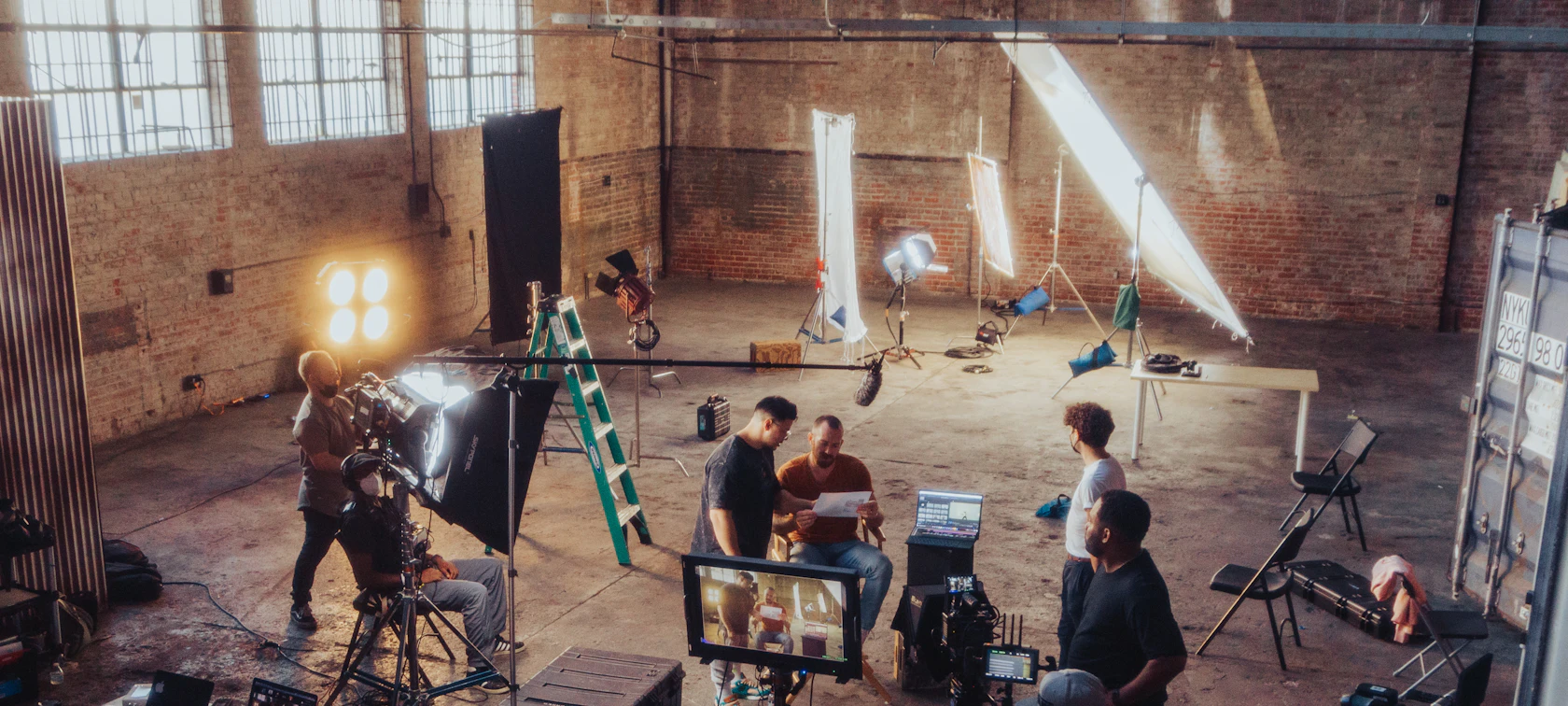 Video production crew working around a camera on set