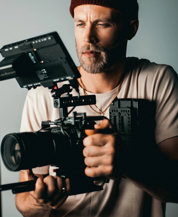Videographer holding a professional video camera